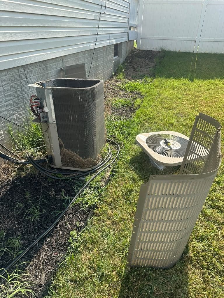 Outdoor AC condenser with top and fan removed for service