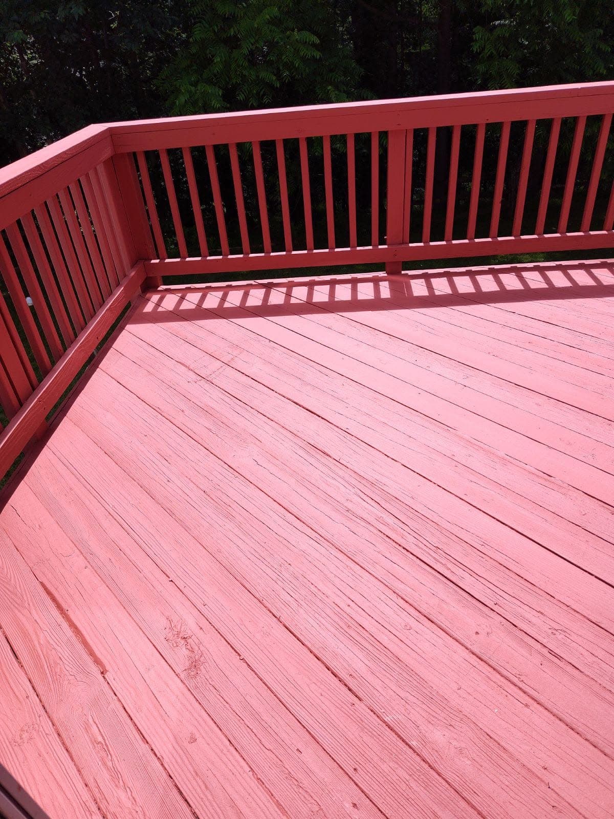 Freshly stained red deck boards and railing